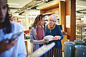 Women shopping for plates in home goods store