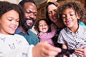 Happy multiethnic family using smart phone