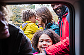 Portrait happy family outside car window