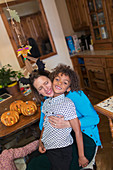 Happy mother and son hugging with Halloween pumpkins