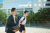 Businesswoman and son outside urban building