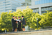 Business people discussing paperwork outdoors