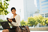 Businesswoman working in urban park