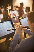 Oboist performing in orchestra