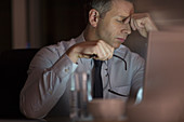 Tired businessman in office at night