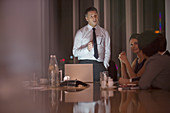 Business people meeting in conference room at night