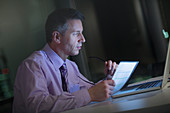 Businessman working late at laptop in office