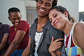 Portrait happy young couple hugging and laughing