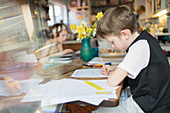 Boy doing homework at dining table