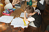 Boy homeschooling at dining table