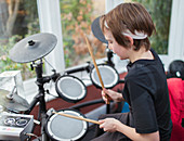 Boy playing electronic drums