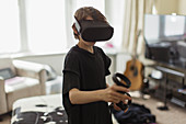 Boy playing video game with VRS goggles
