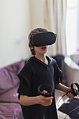 Boy playing video game with VRS goggles