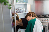 Mother and son looking into refrigerator