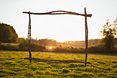 Wood stick frame overlooking sunny tranquil rural view