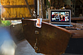 Friends video chatting on laptop screen on wooden boat