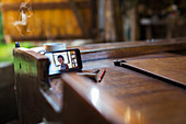 Colleagues video chatting on smart phone on wooden boat