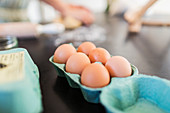 Close up fresh brown eggs in carton