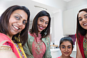 Portrait happy Indian women and girl in saris and bindis