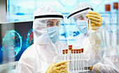 Scientists in clean suits researching coronavirus vaccine