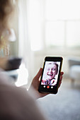 Happy women friends video chatting on smart phone screen