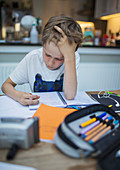 Focused boy home schooling at table