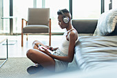 Young woman listening to music and digital tablet