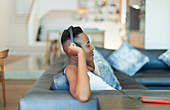 Smiling, serene young woman listening to music