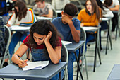 Focused girl student taking exam