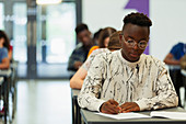 Focused boy student taking exam