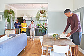 Mature couples setting dining table for lunch