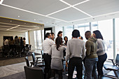 Business people standing in huddle in office