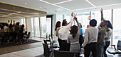 Business people cheering in huddle