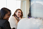 Smiling businesswoman listening in meeting