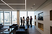 Business people talking in highrise office lobby
