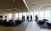 Business people walking in modern office lobby