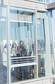 Business people talking at sunny office window