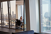 Businesswoman in urban highrise conference room