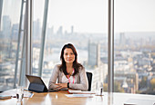 Businesswoman working in urban conference room