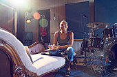 Portrait female musician song writing in studio