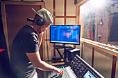 Male music producer working at sound board