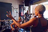 Female musician singing into microphone