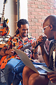 Musicians with laptop and electric guitar