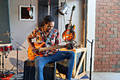 Male musician playing electric guitar