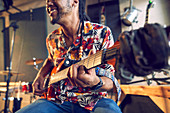 Male musician playing electric guitar