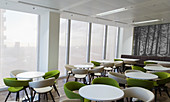Tables and chairs in office lounge