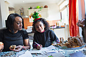 Mother and daughter writing Christmas cards