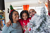Happy family decorating Christmas tree