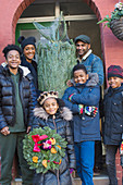 Family with Christmas tree and wreath