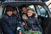 Portrait brothers and sister with Christmas tree